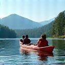 Happy family kayaking on a lake with mountains in the background